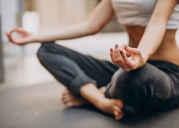 Young woman practicing yoga at home